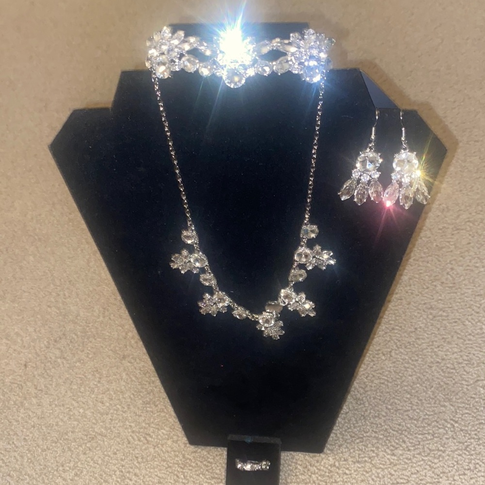 Brand new silver rhinestone necklace, earrings, ring and bracelet set.